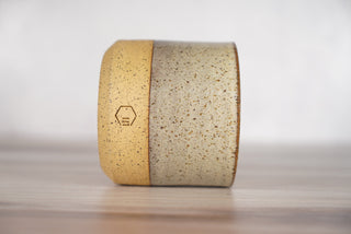 Birch pattern candle on light brown speckled ceramic vessel, third view