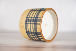 Blue plaid pattern candle on light brown speckled ceramic vessel, second view