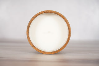 Blue plaid pattern candle on light brown speckled ceramic vessel, fifth view