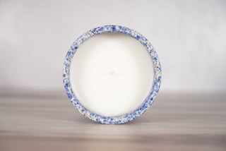 Speckled blue glaze candle on light brown ceramic vessel, fifth view
