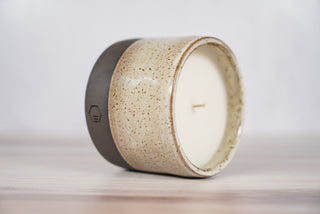 Embers speckled beige and brown glaze candle on dark brown ceramic vessel, second view