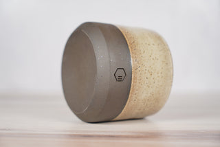 Embers speckled beige and brown glaze candle on dark brown ceramic vessel, fourth view