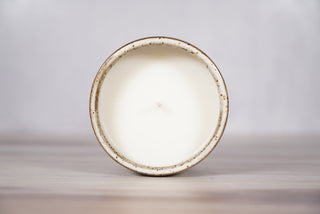 Embers speckled beige and brown glaze candle on dark brown ceramic vessel, fifth view