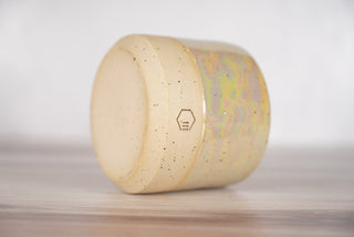 Mother of pearl glaze on light brown speckled ceramic candle vessel, fourth view