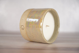 Mother of pearl glaze on light brown speckled ceramic candle vessel, second view
