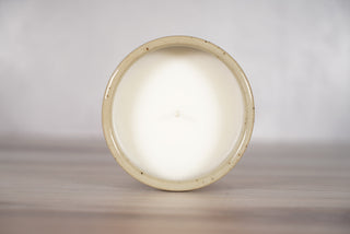 Mother of pearl glaze on light brown speckled ceramic candle vessel, fifth view
