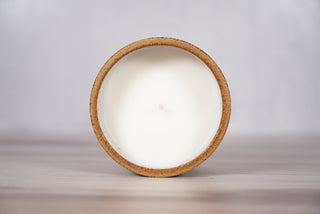 Blue topographic map pattern candle on light brown speckled ceramic vessel, fifth view