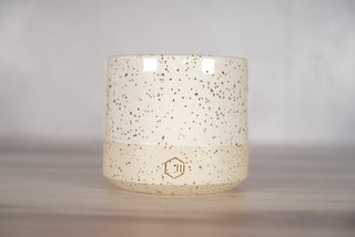 White glaze on white speckled ceramic candle vessel, front view
